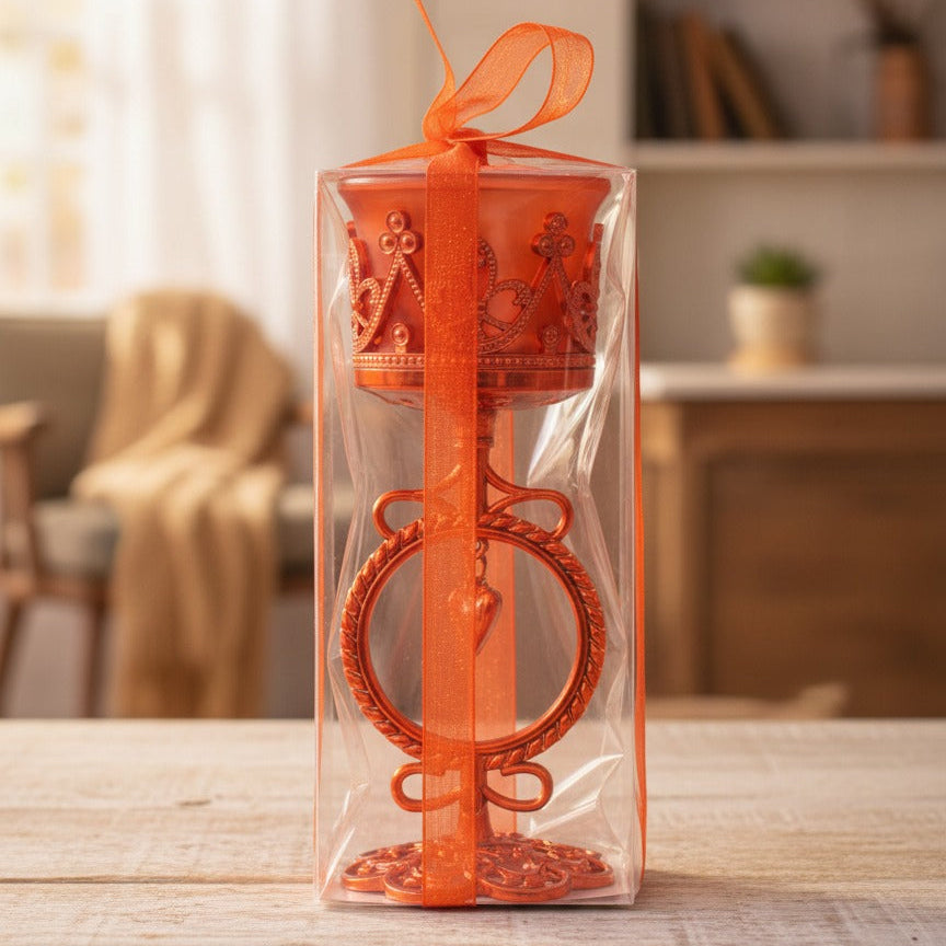 Orange decorative item in clear packaging on a wooden table with a blurred indoor background