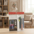 Packaged stationery set on a wooden table with a blurred living room background