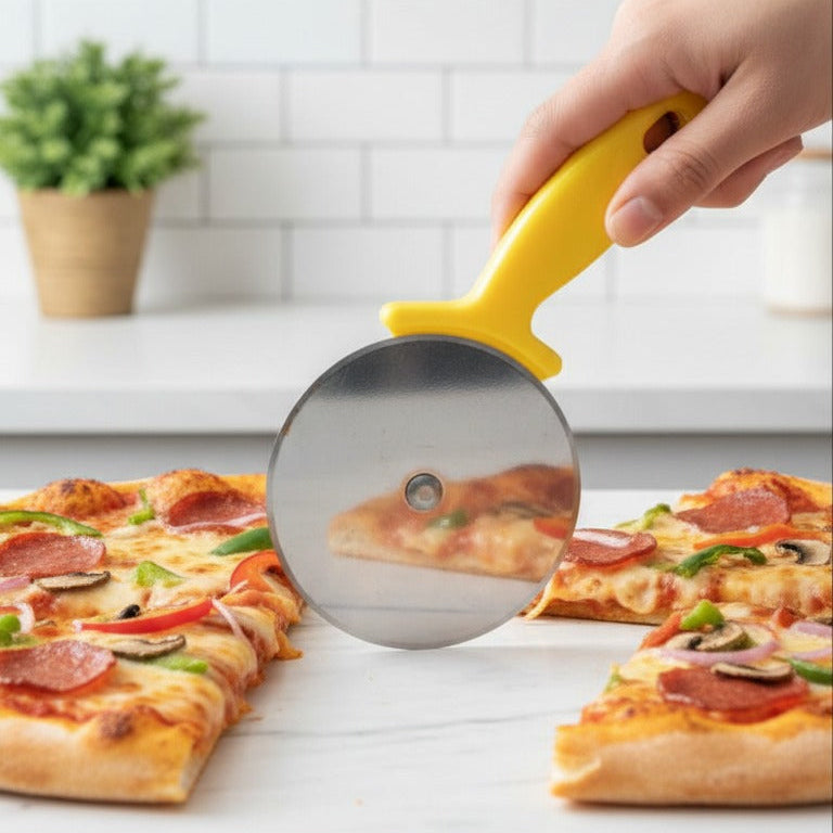 Person using a pizza cutter to slice a pizza on a kitchen counter.