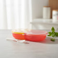 Colorful plastic container on a white surface with a blurred background