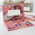 Makeup palette with colorful shades on a white surface, with a blurred bathroom background.